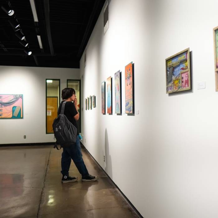 students looking at art exhibits