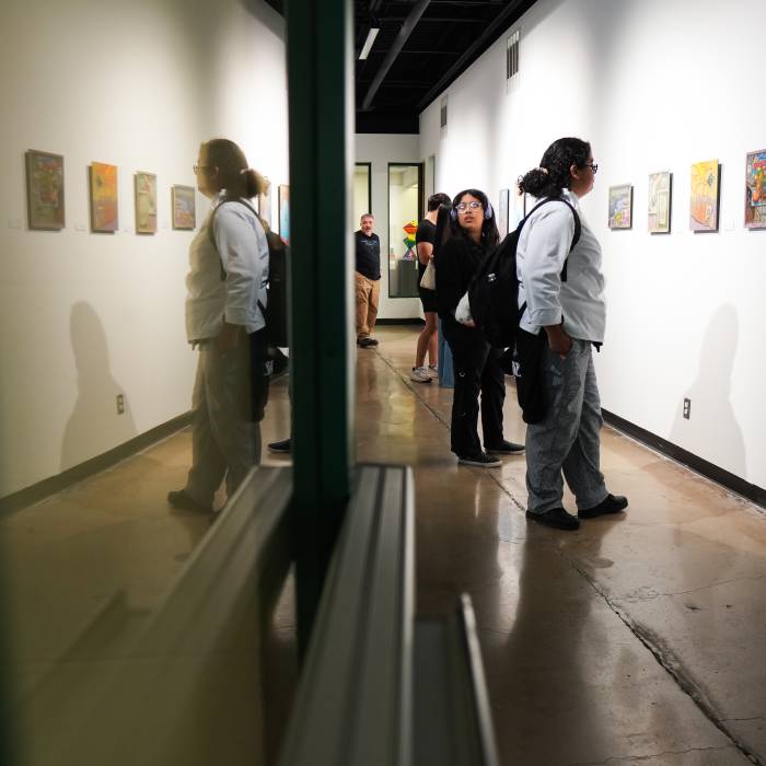 students looking at art exhibits