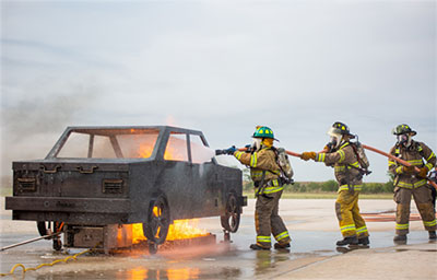students training on the car fire simulator
