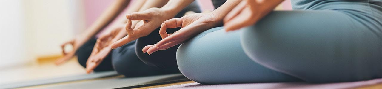 Hands of students in yoga poses