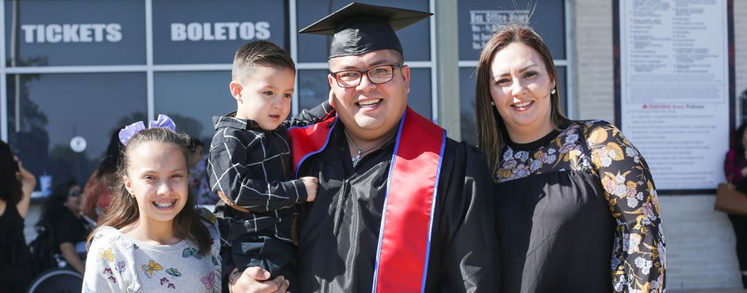 Graduating student posing with his family